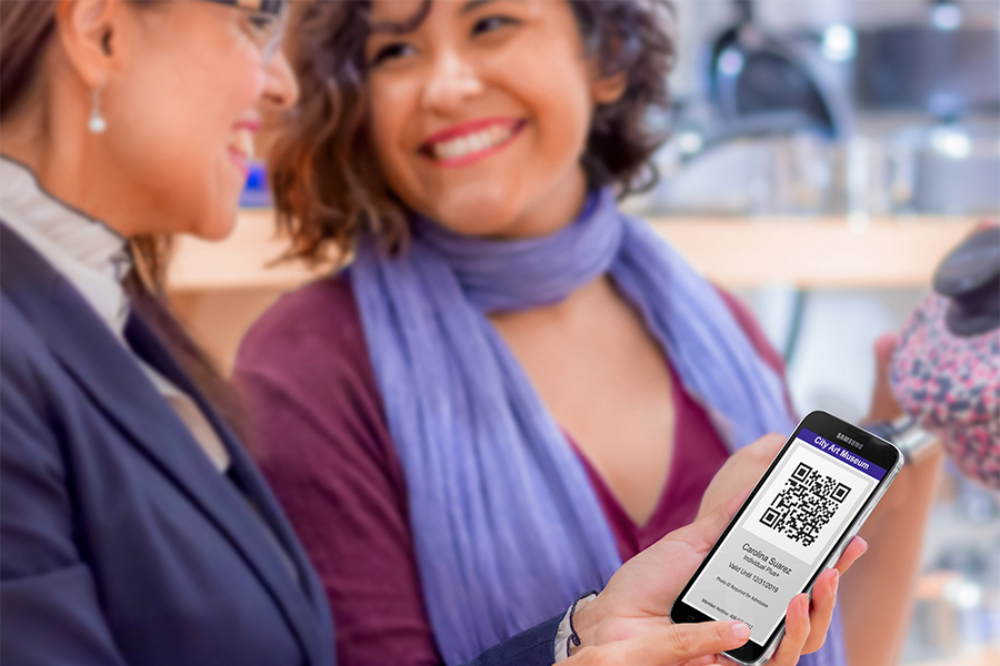 2-mature-ladies-using-mobile-device-at-the-mall